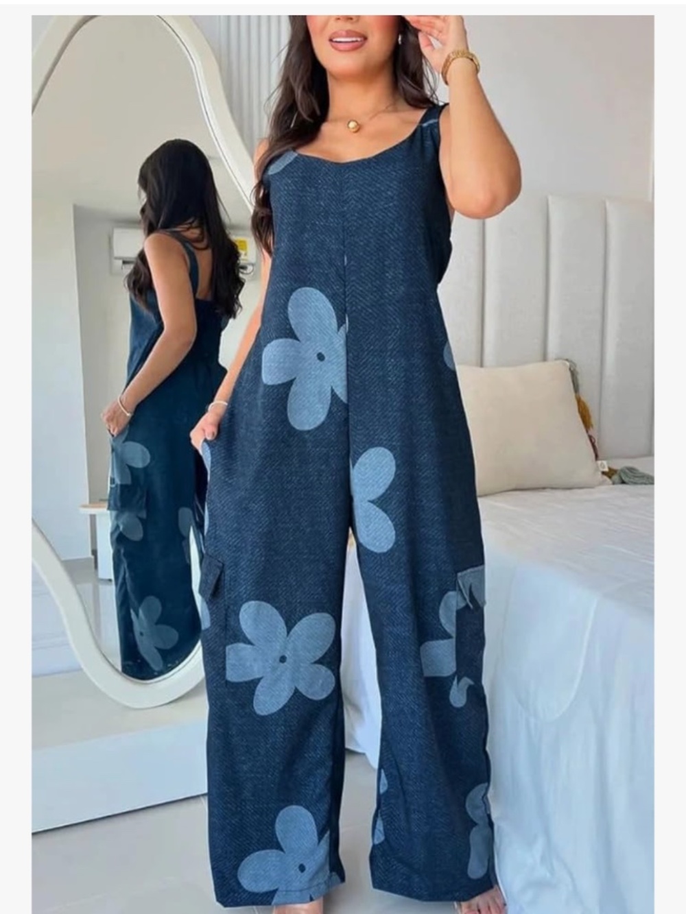 Relaxed wide-leg jumpsuit with a playful large floral print. Sleeveless design w